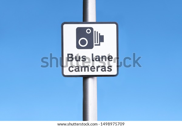 Bus lane camera symbol icon sign against blue sky at\
station in city