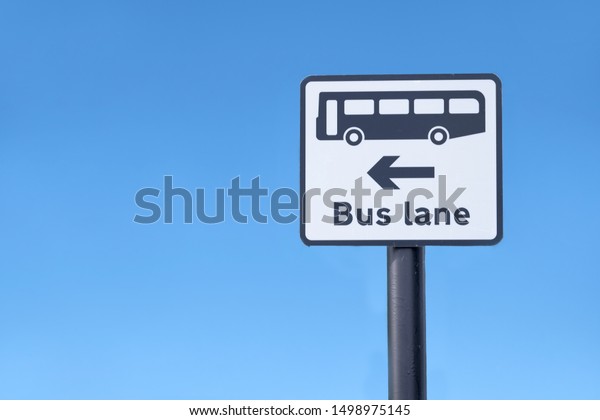 Bus lane symbol sign and direction arrow against blue\
sky uk