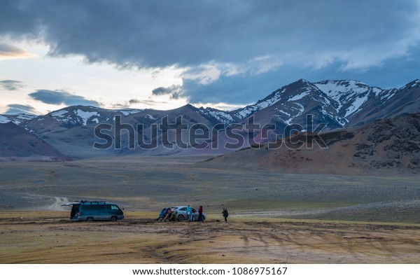 a bus in a mountainous area, the Car got stuck,\
mountains, evening