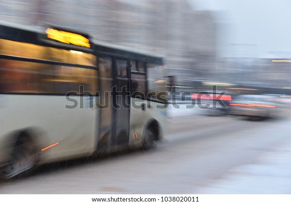 bus\
is moved on winter street in blizzard. Panning\
style