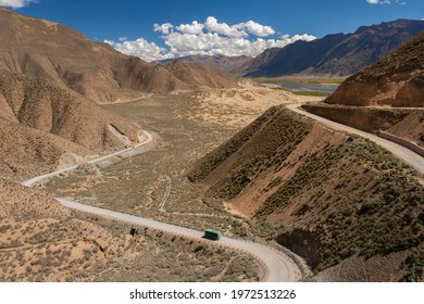 Bus on a desert road high on the Tibetan Plateau near the town of Tsetang in the Tibet Autonomous Region of China.