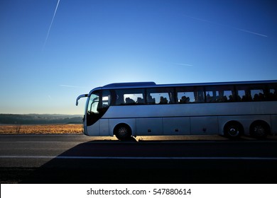 Bus On The Road At Sunset