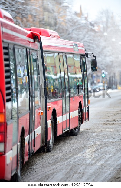 Bus on winter street,\
turning right