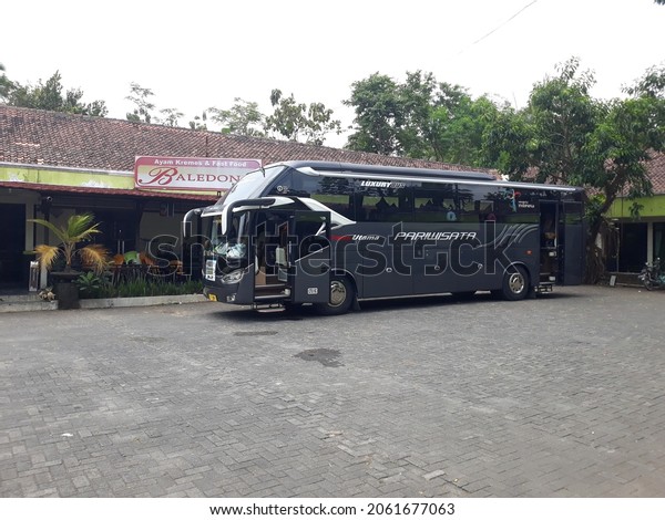 the bus parking in the\
parking lot. October 22, 2021, yogyakarta, Indonesia,  bus\
pariwisata lewat di jalan bus ini membawa wisatawan yang berwisata\
di kota jogja