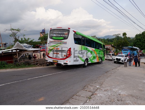 Bus passes on the way. January 9, 2022,\
yogyakarta, Indonesia, kendaraan macet saat long weekend atau\
weekend banyak bus wisata yang lewat di jalanan kota yogyakarta\
membawa wisatawan