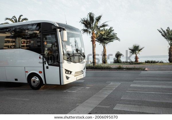 The bus rides on the road, along the sea\
shore, the concept of vacation, rest, transportation of tourists,\
excursions