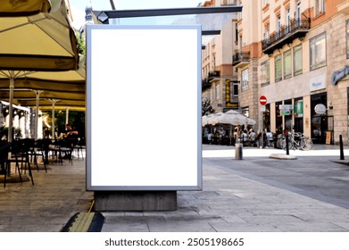 bus shelter with blank ad panel. billboard display. empty white lightbox sign. bus stop. billboard mockup. glass structure. city transit station. urban street. restaurant terrace. outdoor advertising