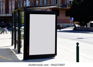 Bus Shelter With Blank Poster Ad Lightbox. Bus Transit Stop. Blank White Billboard Panel. Glass Structure. Urban Setting. City Street. Asphalt Sidewalk. Commercial Space. Background For Mockup