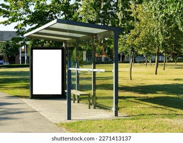 bus shelter at busstop. blank white lightbox. empty billboard and ad placeholder. glass and aluminum structure. transit station. urban setting. city street background. stone sidewalk. base for mockup
