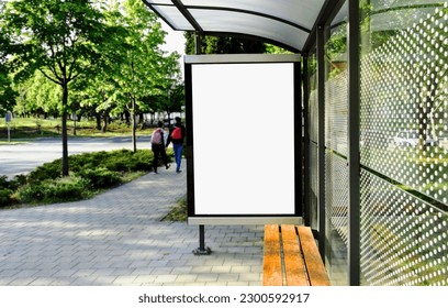 bus shelter at bus stop. transit station. blank white lightbox. empty billboard and ad placeholder. glass and aluminum structure. urban setting. city street background. stone sidewalk. base for mockup