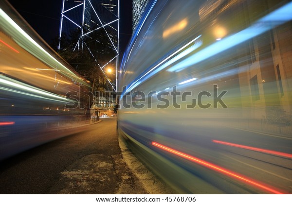 Bus\
speeding through night street. Hong Kong,\
China