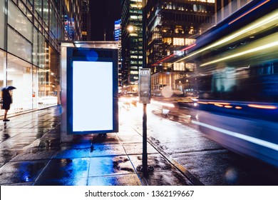 Bus Station Billboard In Rainy Night With Blank Copy Space Screen For Advertising Or Promotional Content, Empty Mock Up Lightbox For Information, Blank Display In Urban City Street With Long Exposure