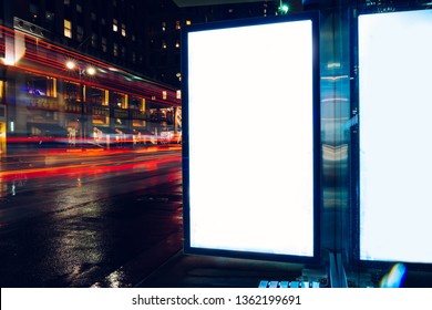 Bus Station Billboard In Rainy Night With Blank Copy Space Screen For Advertising Or Promotional Content, Empty Mock Up Lightbox For Information, Blank Display In Urban City Street With Long Exposure