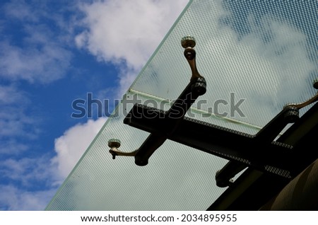 bus stop glazing. glass canopy attached at n several points to the metal structure. Gaps between the sky that have dots as protection against sunlight Foto stock © 