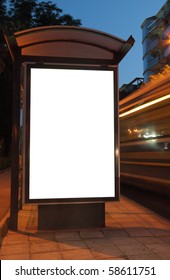 Bus Stop At Night. Blurred Light From The Passing Vehicles Are Visible. This Is For Advertisers To Place Ad Copy Samples On A Bus Shelter.