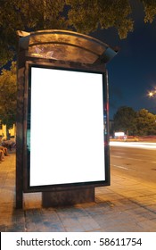 Bus Stop At Night. Blurred Light From The Passing Vehicles Are Visible. This Is For Advertisers To Place Ad Copy Samples On A Bus Shelter.