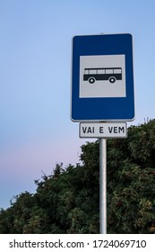 A Bus Stop In Portimao With A Portuguese Description Vai A Vem, Meaning Comes And Goes. Sky And Bush Background In Fall. A Blue Road Sign With A Black Bus. Faro, Algarve, Portugal Travel Destination