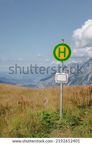 Bus stop sign in the nowhere at the Enzianhütte in the Allgäu mountains in Germany.