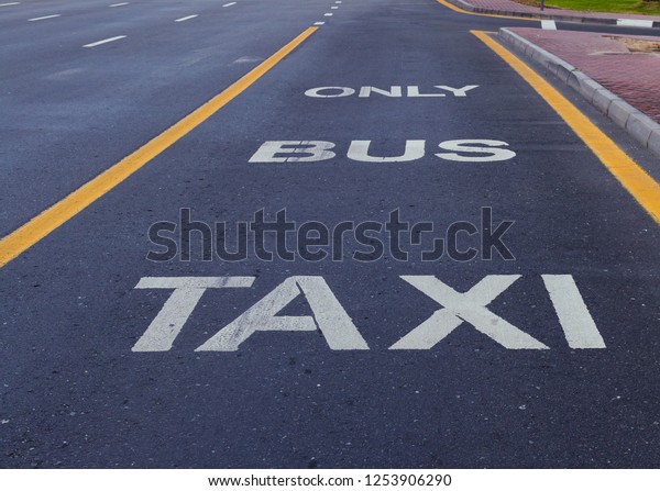 Bus and\
Taxi sign painted on street transport\
traffic