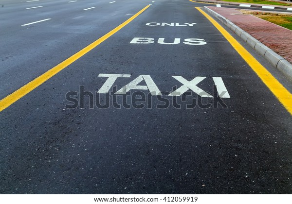 Bus and Taxi sign painted\
on street