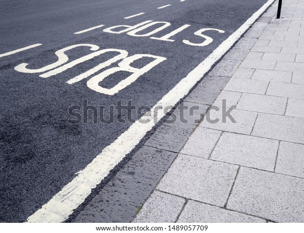 Bus top sign painted on\
asphalt road