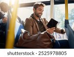 Bus, travel and man by window reading for journey, commute and passenger in city. Public transport, station and person on vehicle with literature, book and novel on trip in urban town, road and metro