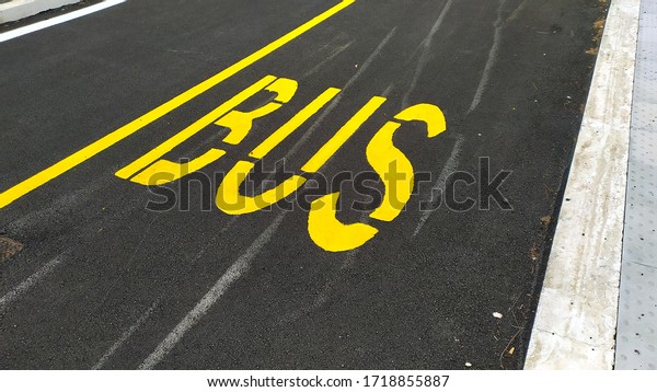 BUS writing painted yellow on new asphalt stretch,\
perspective view