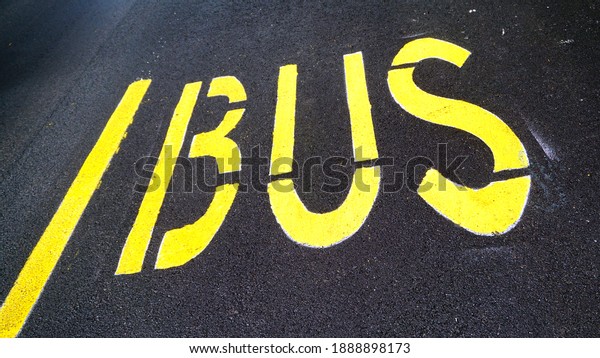 BUS writing painted yellow on new asphalt stretch,\
perspective view. It delimits the bus passage and stop lane.\
conceptual image