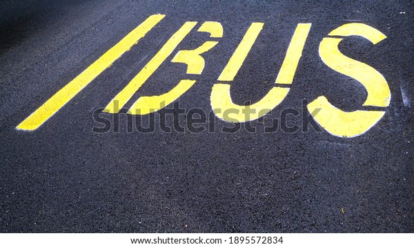 BUS writing painted yellow on new asphalt stretch,\
perspective view. It delimits the bus passage and stop lane.\
conceptual image