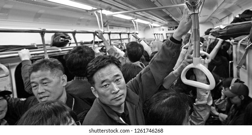 Busan, South Korea - October 29, 2011: A Crowded Subway Car. Taken In Busan, South Korea, But Suitable To Illustrate Tired And Busy People, Busy Lives, Urban Environments, Or Commutes And Commuting.