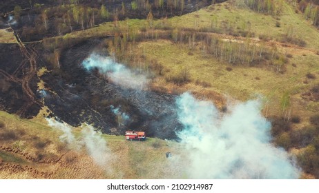 Bush Fire And Smoke. Drought Fire Engine, Truck On Firefighting Operation. Wild Open Fire Destroys Grass. 4K Aerial View Spring Dry Grass Burns During Drought Hot Weather. Bush Fire And Smoke.