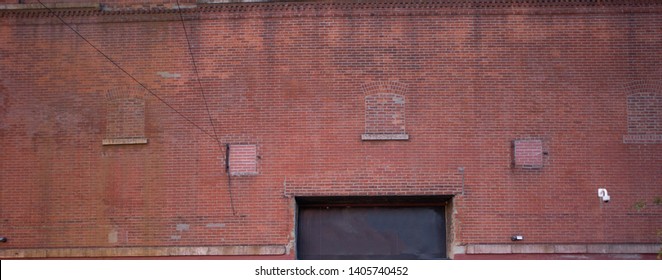 Bushwick, Brooklyn. old factory facade Red brick wall with some sign of repaint and water mark 