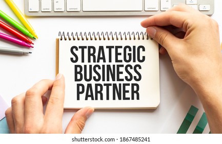 Businesman Hold Notepad With Text STRATEGIC BUSINESS PARTNER. White Background. Business