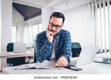 Businesman reading newspapers at work