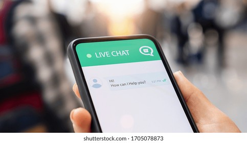 Businesperson use customer service and support live chat with chatbot and automatic messages or human servant outdoor. Assistance and help with mobile phone app. Smartphone helpdesk for feedback cell.