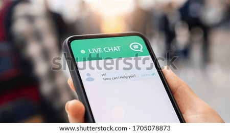 Businesperson use customer service and support live chat with chatbot and automatic messages or human servant outdoor. Assistance and help with mobile phone app. Smartphone helpdesk for feedback cell.