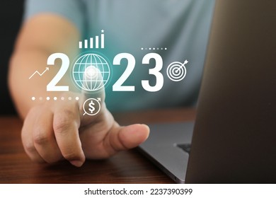 Business 2023 tech button. Technology with businessman finger press starting global Newyear plan. Touch screen networking communication