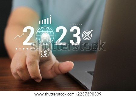 Business 2023 tech button. Technology with businessman finger press starting global Newyear plan. Touch screen networking communication