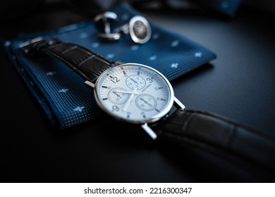 Business accessories. Mens watch and cufflinks isolated on black background. - Shutterstock ID 2216300347