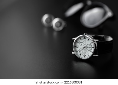 Business Accessories. Mens Watch And Cufflinks Isolated On Black Background.