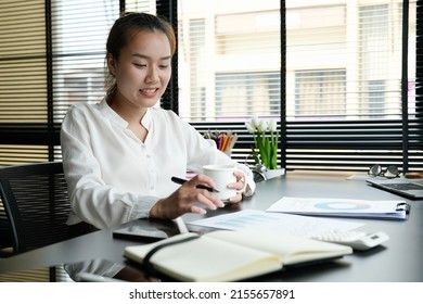 Business Accountant Asian Woman Analysis Financial Report At Her Office