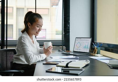 Business Accountant Asian Woman Analysis Financial Report At Her Office