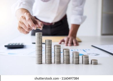 Business accountant or banker, businessman calculate and analysis with stock financial indices and putting growth stacking coin and financial costs wisely and carefully, investment and saving concept.
