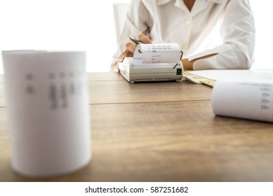 Business Accountant Or Financial Adviser Making Calculations Using Adding Machine.