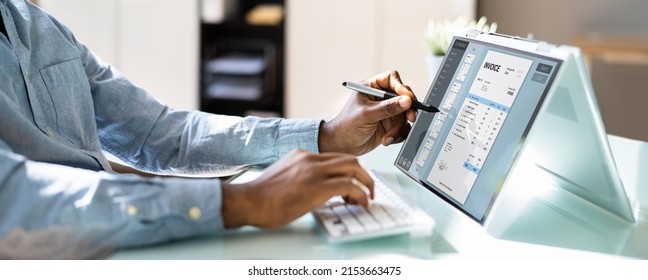 Business Accountant Using Electronic Bill On Laptop Computer
