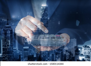 Business Accountant Woman Using Calculator For Calculating Financial Investment Tax Income And Profit Estimate, Double Exposure Of Businesswoman Hands Is Holding Calculator With Cityscape Background