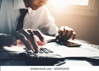 Business Accounting, Business Man Using Calculator With Computer Laptop, Budget And Loan Paper In Office. 