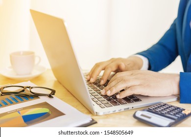Business accounting plan concept, Working on desktop laptop computer with calculator for making business, business man hand working with laptop computer on wooden desk business investment advisor. - Shutterstock ID 1548505649