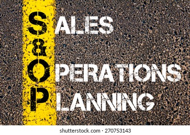 Business Acronym SOP As Sales And Operations Planning. Yellow Paint Line On The Road Against Asphalt Background. Conceptual Image