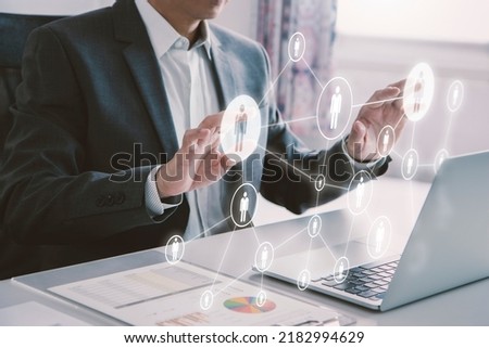 Business administrator in action of manpower or human resource planning or business organisation on a virtual dashboard.
